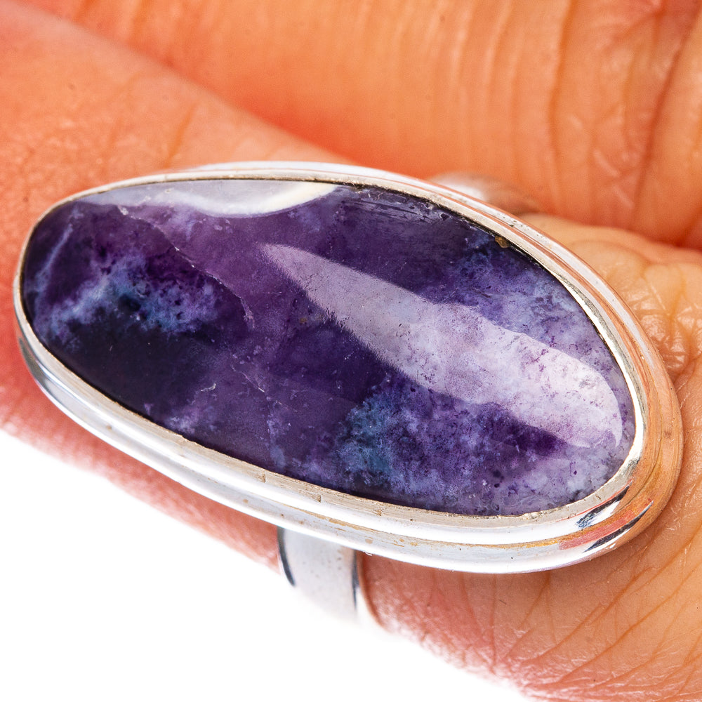 Oval purple opal ring in silver-toned setting with polished bezel, visible gem surface