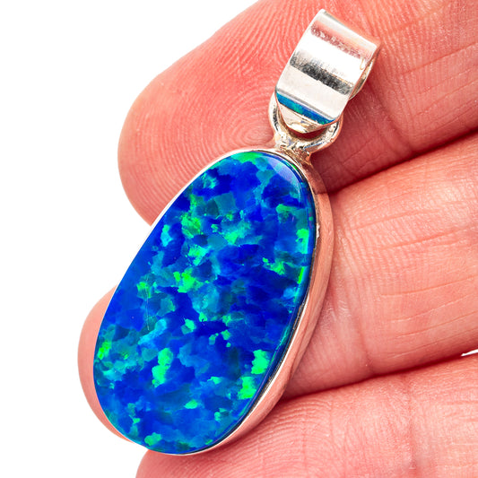 Sterling silver lab opal pendant with blue teardrop stone and polished bezel