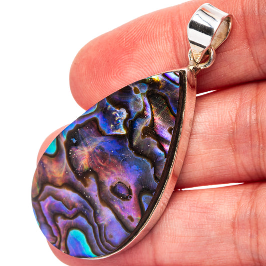 Abalone shell teardrop pendant in iridescent purple, blue, and green on silver bail