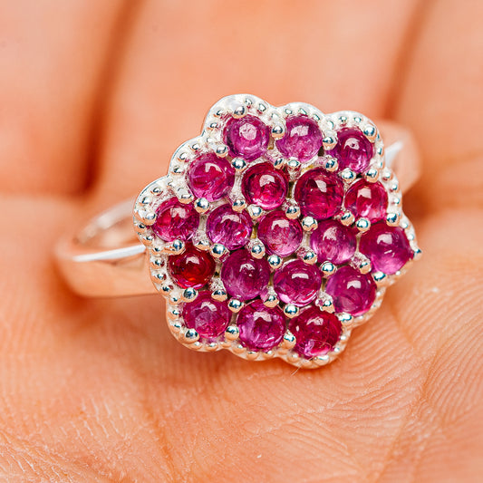 Sterling silver ruby cluster ring with clustered round pink stones and open side band