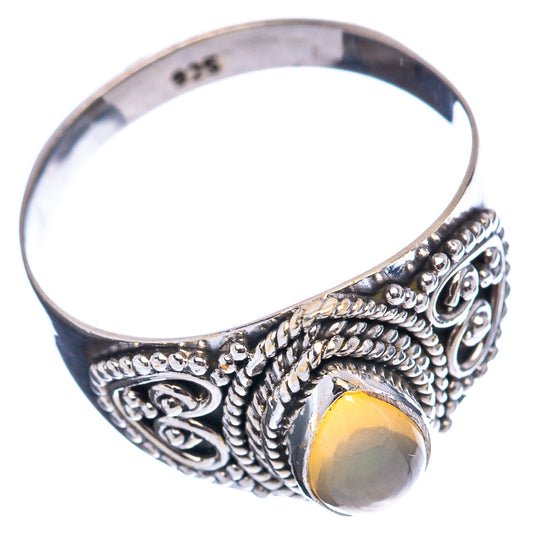 Sterling silver opal ring with oval yellow opal cabochon and decorative scrollwork band