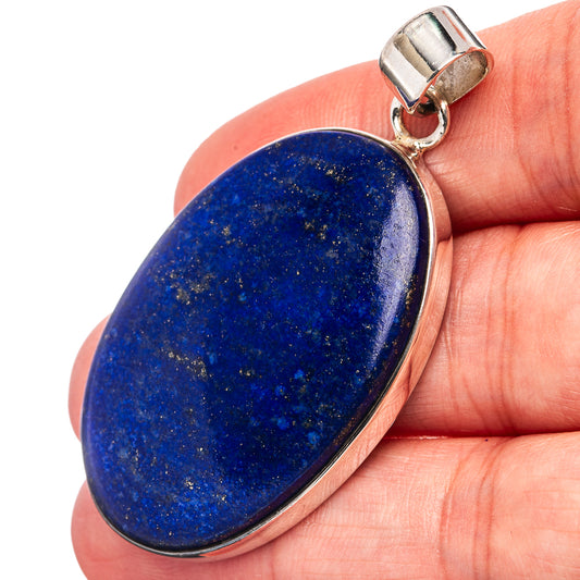 Oval lapis lazuli pendant with blue stone and silver bail, polished bezel setting