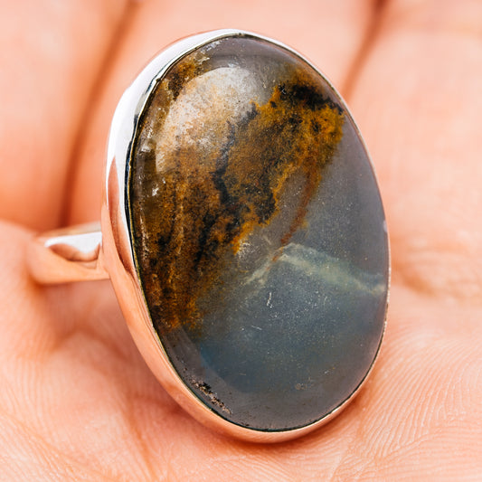 Oval cabochon sterling silver ring with dark blue-gray and speckled brown stone
