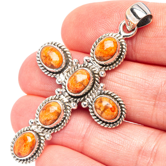 Sterling silver cross pendant with orange sponge coral oval stones