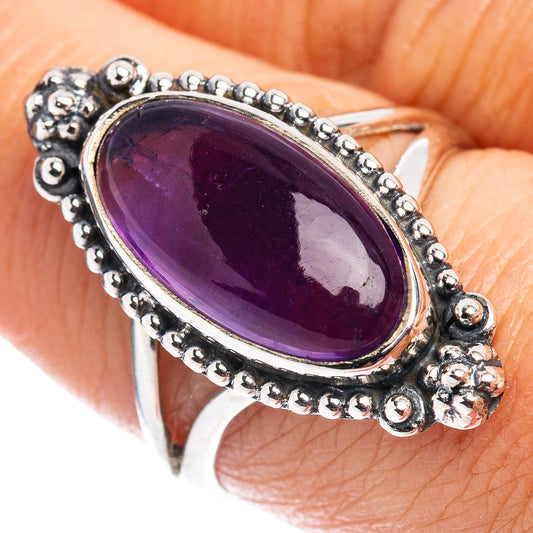 Sterling silver amethyst oval ring with beaded bezel and purple gemstone top view