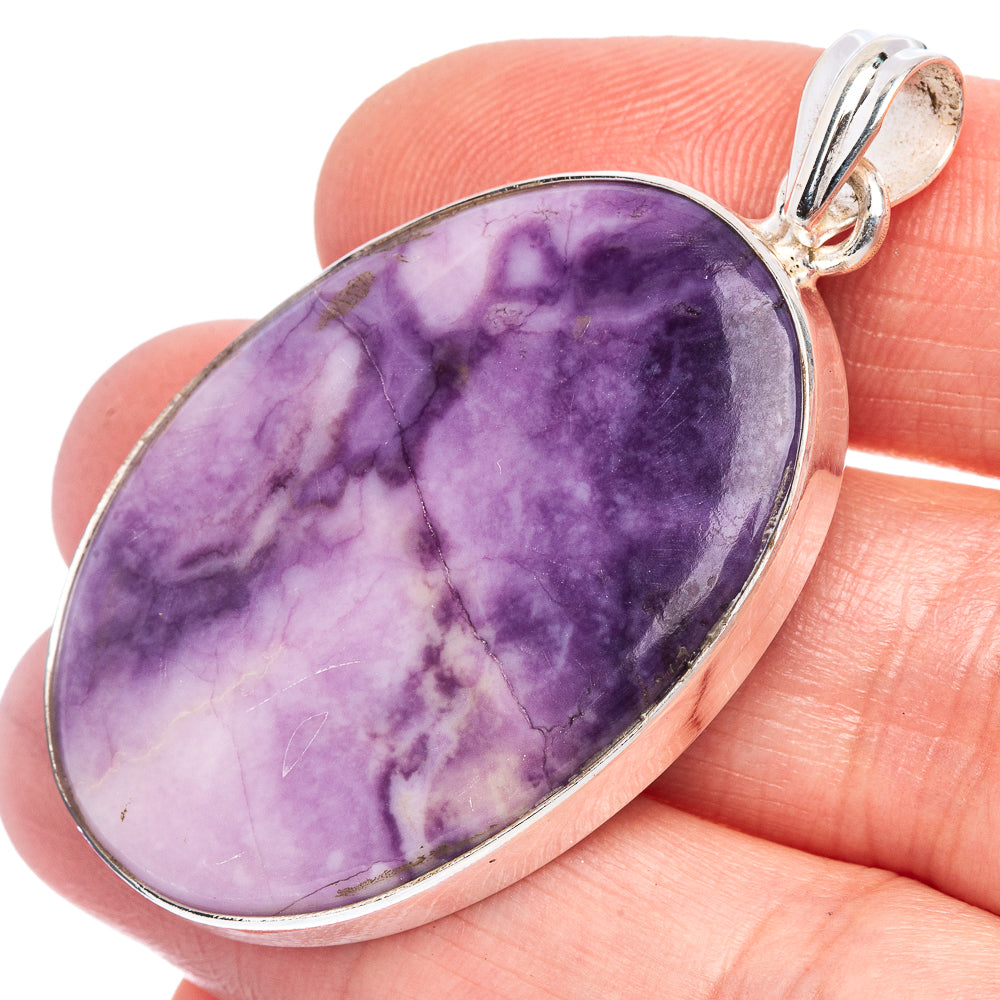 Sterling silver pendant with teardrop purple Tiffany Stone and polished bezel