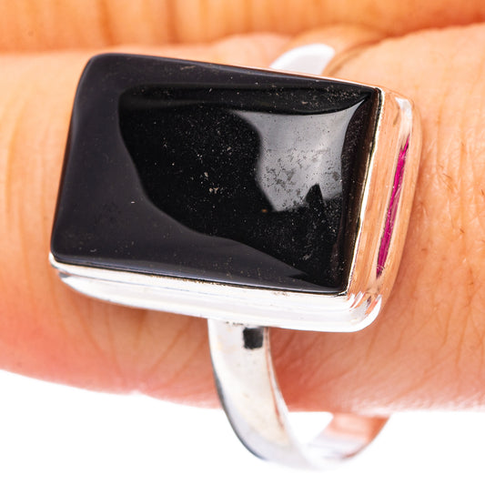 Sterling silver ring with black onyx square stone, glossy bezel on finger