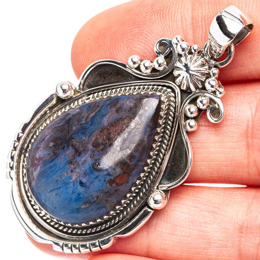 Sterling silver apatite pendant with blue teardrop cabochon and ornate frame, bail top