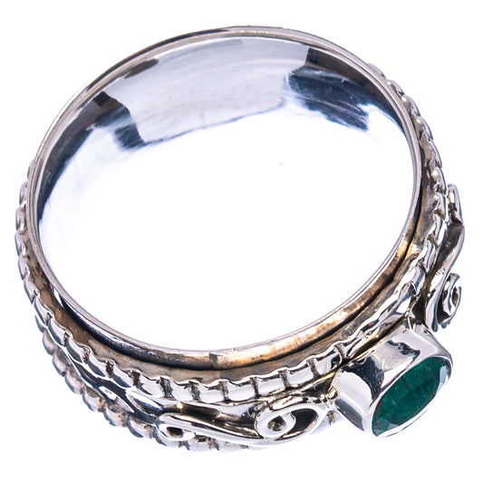 Sterling silver ring with ornate band and green oval side gemstone