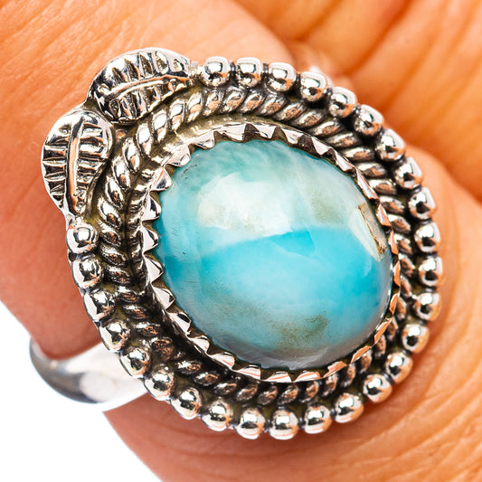 Sterling silver ring with bezel-set oval blue-green stone and beaded border