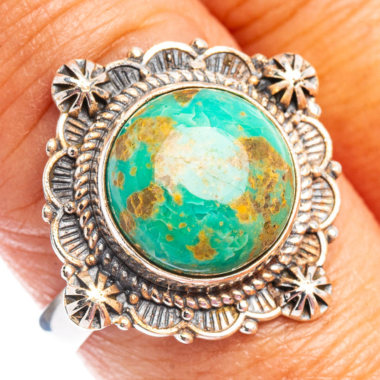 Turquoise cabochon sterling silver ring with ornate sunburst border and star accents