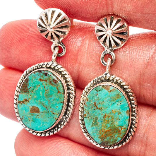 Turquoise oval cabochon dangle earrings with sunburst silver top and drop setting