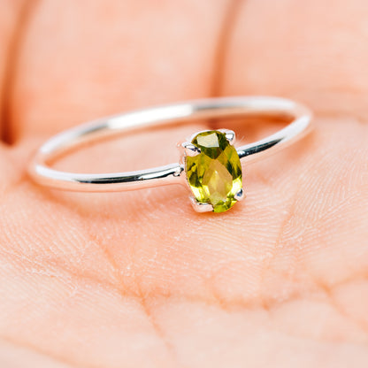Sterling silver ring with green oval peridot on slender band