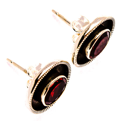 Garnet stud earrings, oval red stones framed by black bezels, sterling silver posts