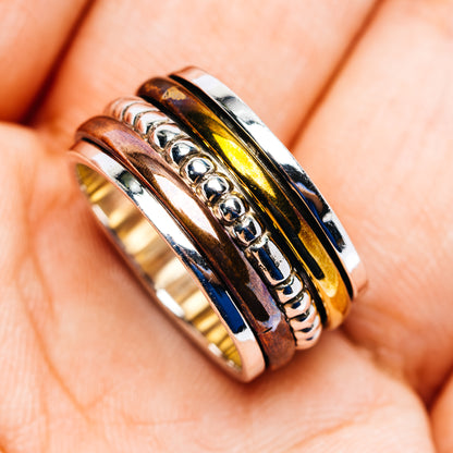 Three-tone spinner ring with polished sterling silver, gold-tone and blue inlay; size 6.75
