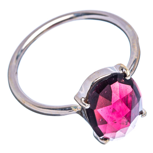 Sterling silver ring with faceted pink-red garnet teardrop center stone
