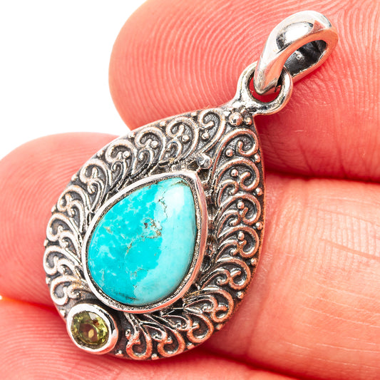 Sterling silver pendant with oval Kingman turquoise, peridot accents and ornate filigree