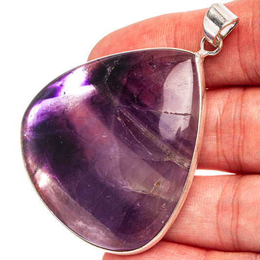 Silver-plated fluorite pendant with teardrop purple gemstone and metal bail.