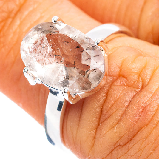 Sterling silver ring with large oval faceted clear gemstone in four-prong setting