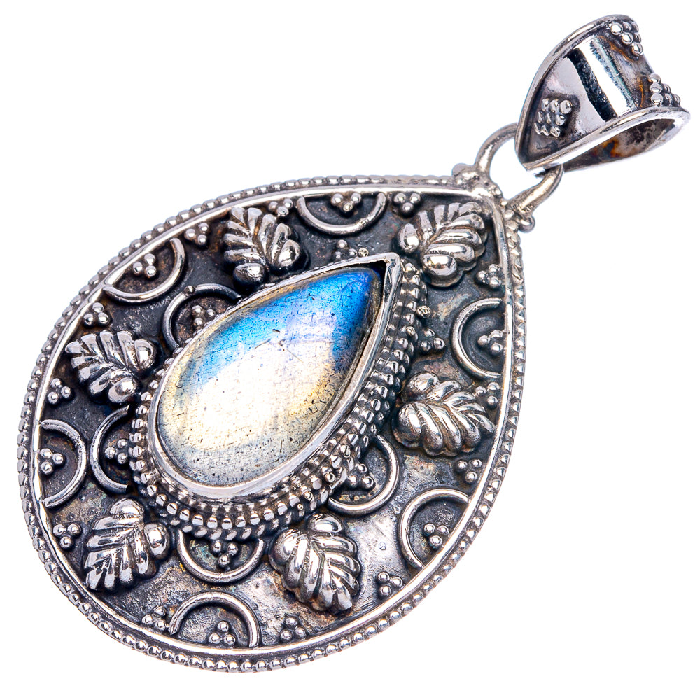 Teardrop labradorite pendant in ornate antique silver-tone setting, blue oval flash.