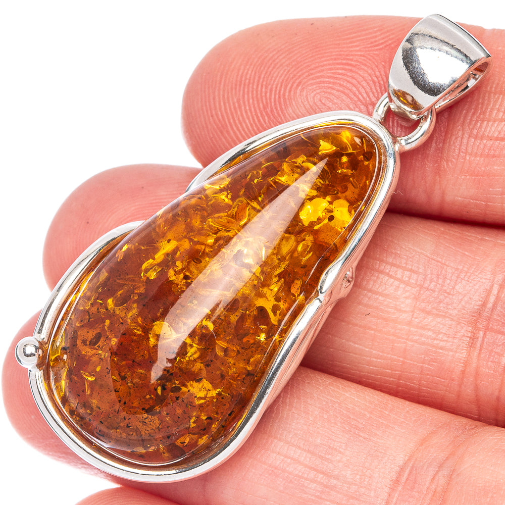 Sterling silver amber pendant with teardrop Baltic amber stone, polished setting.
