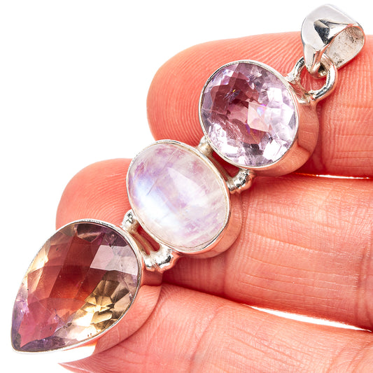 Sterling silver pendant with three faceted purple and lavender gemstones and a moonstone center