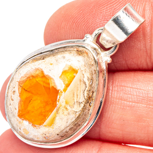 Oval sterling silver pendant with orange fire opal stone in bezel setting