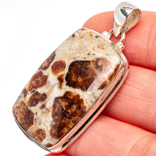 Sterling silver pendant with rectangular bezel, mottled tan and reddish-brown stone