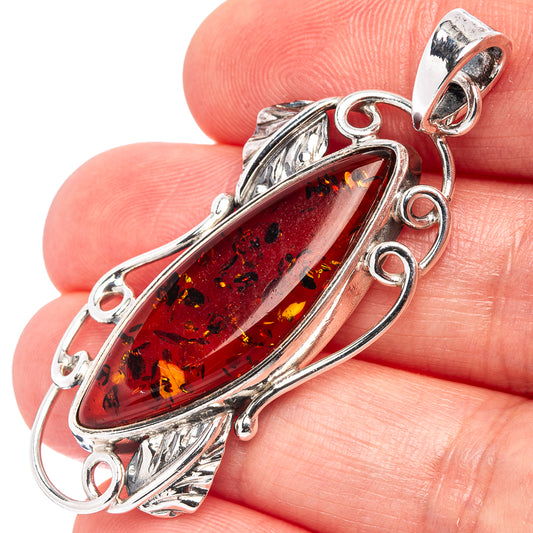 925 sterling silver Baltic amber oval pendant with leaf-like inclusions, ornate metal frame