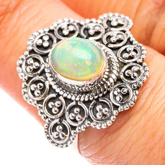 Sterling silver opal ring with oval opal cabochon and ornate round filigree setting