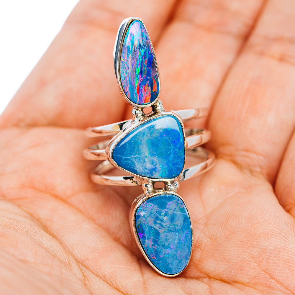 Three-stone fire opal ring in sterling silver, blue teardrop cabochons on band
