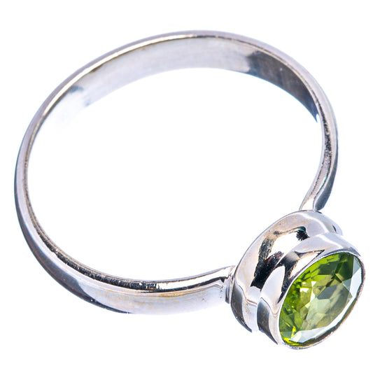 Faceted peridot ring in .925 sterling silver, green faceted stone on side view