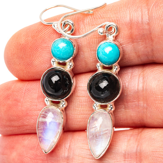 Turquoise, black, and moonstone dangle earrings in sterling silver