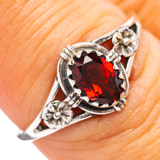 Dainty sterling silver ring with oval garnet red gemstone and decorative floral settings