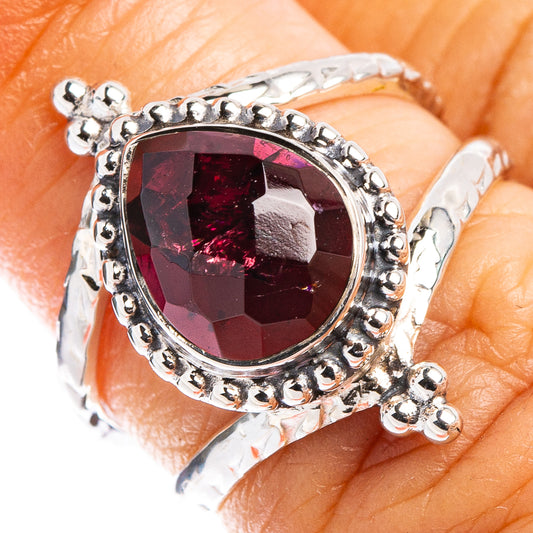 Sterling silver garnet ring with oval faceted dark red gemstone and bead halo