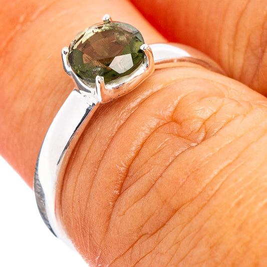 Sterling silver ring with faceted dark green moldavite stone, open setting detail