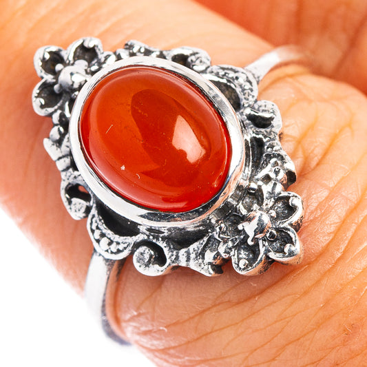 Sterling silver dainty ring with oval red-orange carnelian-style gemstone halo