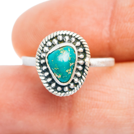 Turquoise inlay sterling silver ring with oval bezel and textured round border