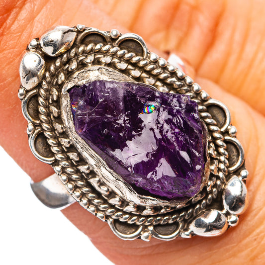 Silver amethyst teardrop ring with ornate rope bezel, faceted purple gemstone