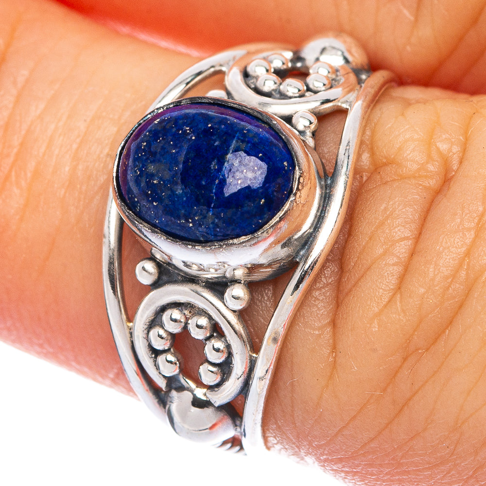 Sterling silver ring with oval lapis lazuli cabochon and ornate scrollwork setting