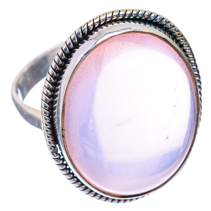 Rose quartz oval cabochon ring with twisted rope bezel and 925 silver band, angled view