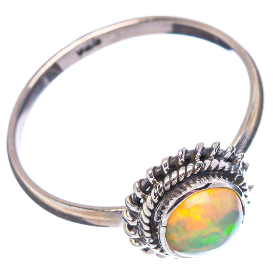 Sterling silver opal ring with round multicolor gemstone and ornate bezel.