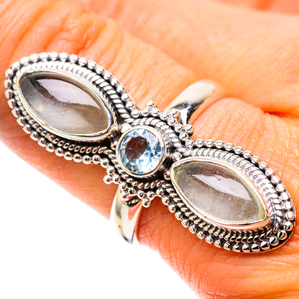 Sterling silver ring with two oval white stones and a round blue gemstone