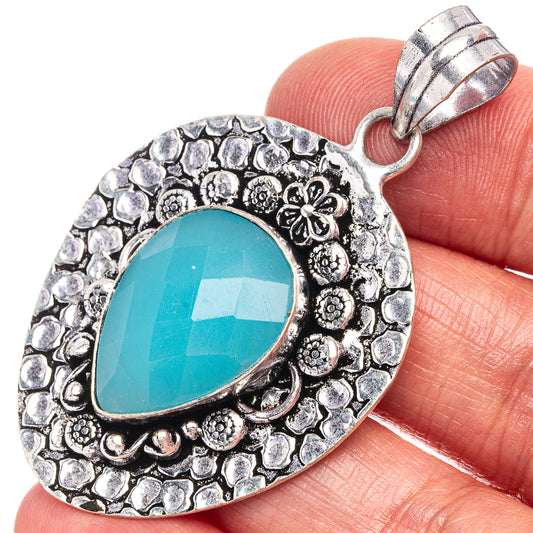 German silver chalcedony pendant with oval turquoise stone and ornate border