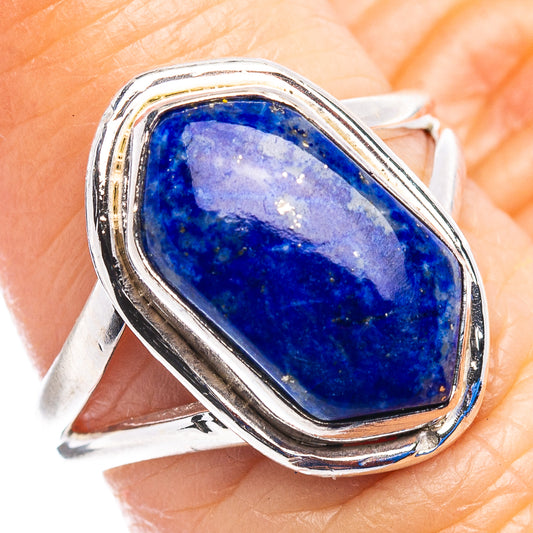 Sterling silver lapis lazuli ring on finger, raised bezel with oval blue cabochon
