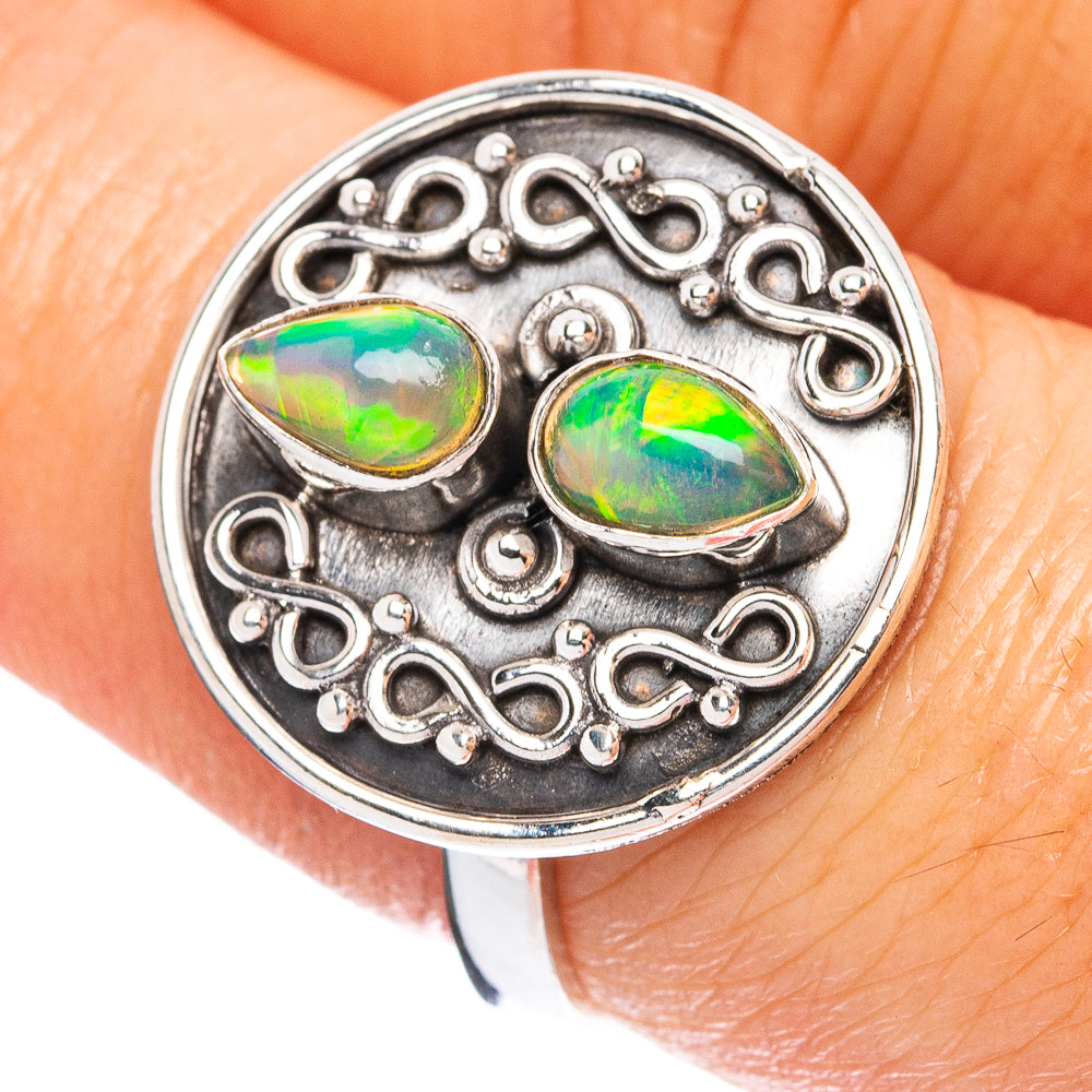 Sterling silver opal ring with two oval cabochons, green and blue fire, ornate bezel