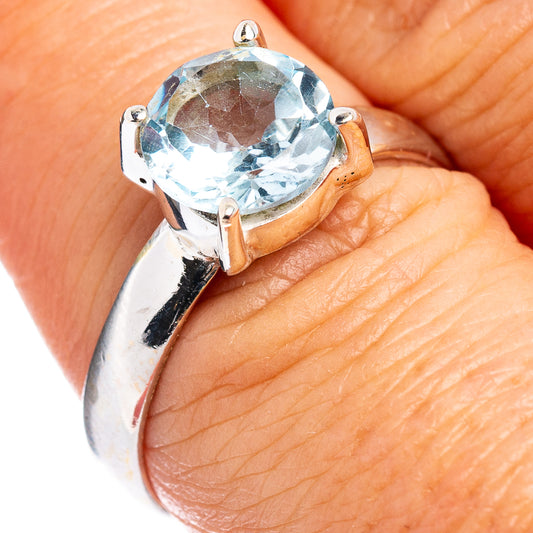 Sterling silver topaz ring with faceted light blue gemstone, prong-set band