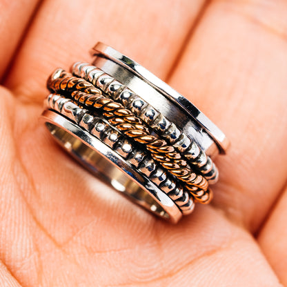Sterling silver spinner ring with copper braided inlay and engraved dots, top view