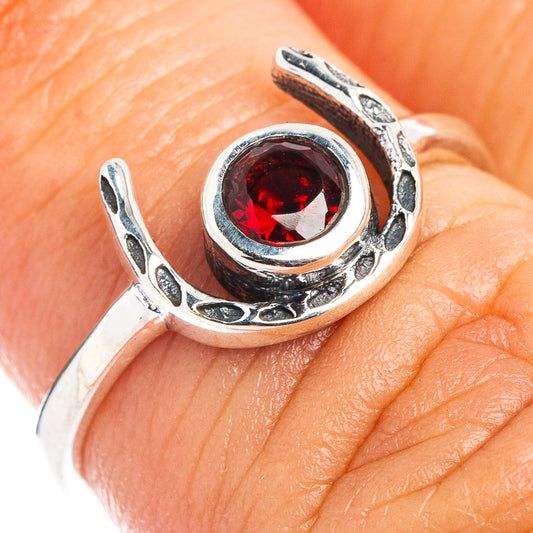 925 sterling silver horseshoe ring close-up with round red gemstone on finger