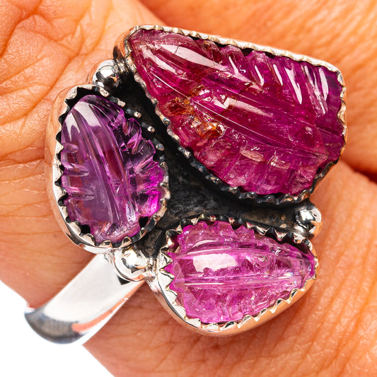Sterling silver ring with carved purple gemstones in a dark prong setting
